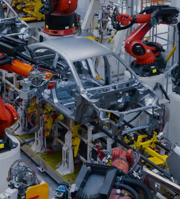 Robotic arms welding a car body shell on an automated production line