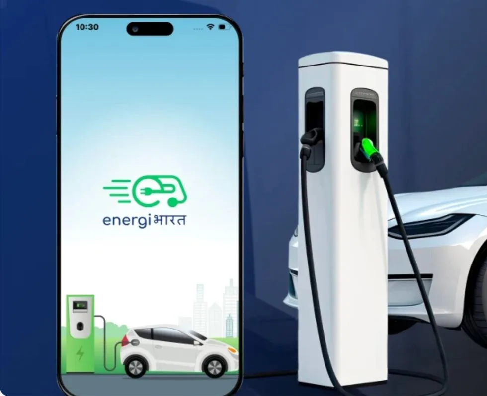 The Energi Bharat app on a phone beside an EV charging station