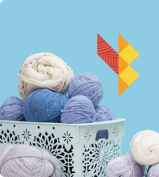 Skeins of yarn in a basket beside the Yarn Bazaar logo
