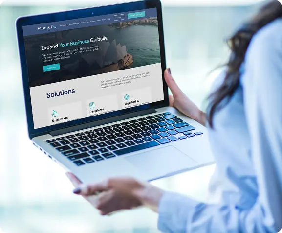 The Shan & Co. solutions page open on a laptop