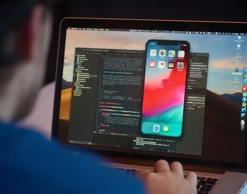 A developer building a React Native app, the phone preview beside the editor